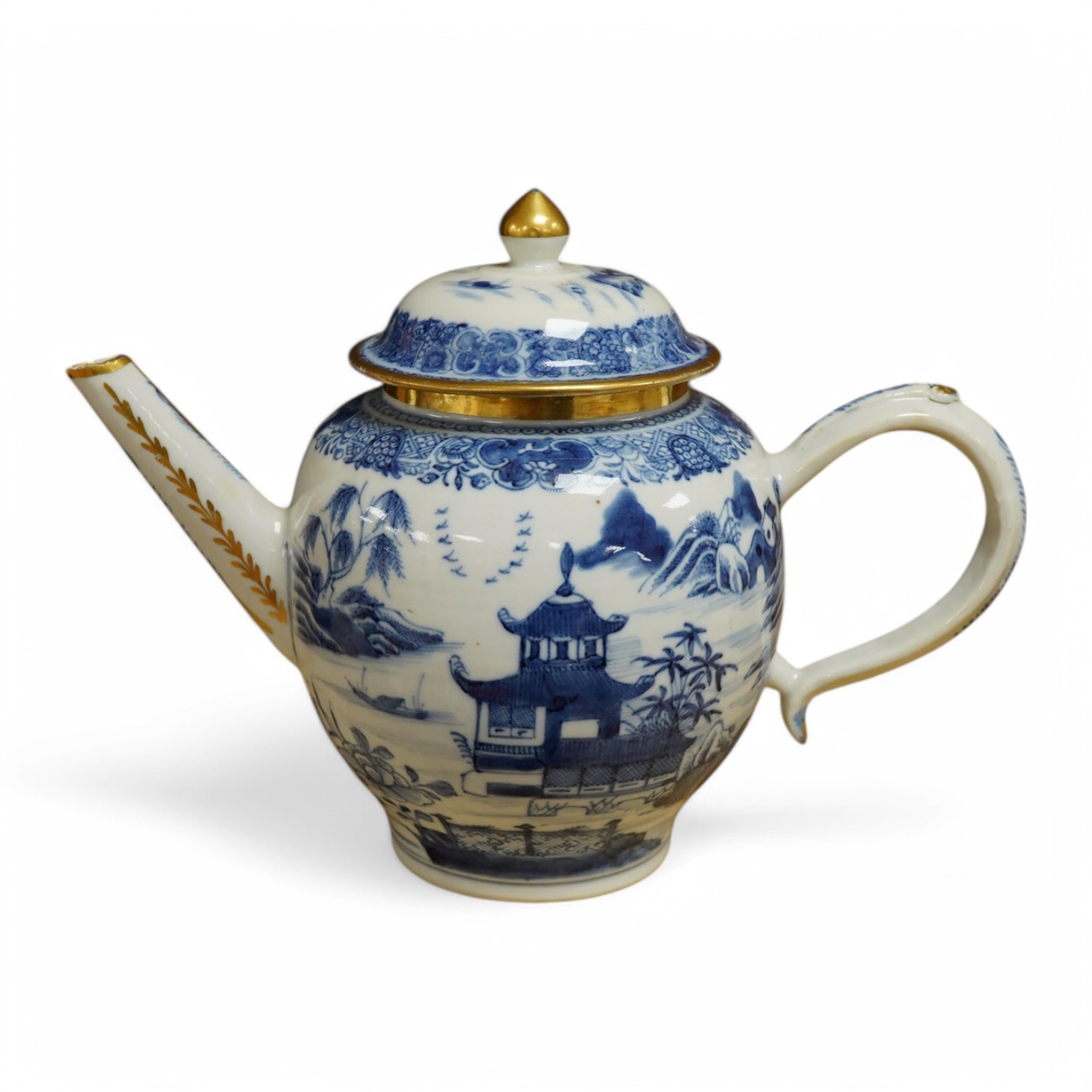 A Chinese export blue and white teapot, c.1790, painted with pagodas, 24cm wide. Condition - some chipping and firing cracks